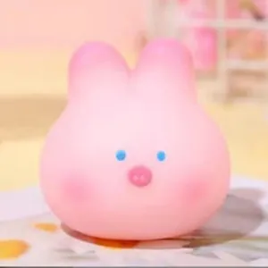 Detail of a cute pink squishy toy for stress relief with a minimalist rabbit face design.