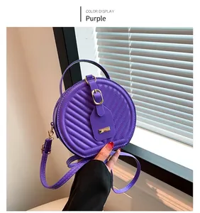 Detailed view of a trendy purple quilted round crossbody bag for fashion-conscious women