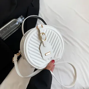 Chic white round crossbody bag with quilted chevron pattern and elegant gold hardware
