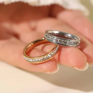 Close-up detail of stainless steel rings with full pavé square-cut cubic zirconia stones.