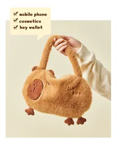 Hand holding a cute plush capybara shoulder bag showing space for phone and cosmetics.