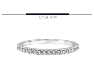 Macro view of a minimalist S925 sterling silver eternity ring with moissanite stones.