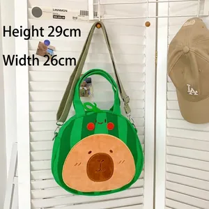 Green Capybara plush tote bag with watermelon pattern hanging on a white wall, 29x26cm