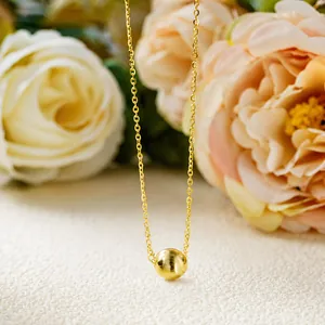 Macro shot showing the fine texture of the brushed cat-eye bead on a gold S925 chain