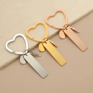 Detailed macro view of heart-shaped stainless steel keychains in silver, gold, and rose gold