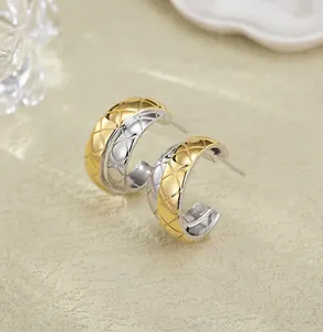 Detailed macro view of S925 sterling silver two-tone hoop earrings with quilted pattern design