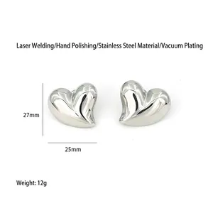 Detailed macro view of oversized heart earrings featuring 27mm x 25mm dimensions and weight.