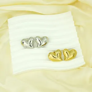 Bold oversized heart-shaped stud earrings in gold and silver tones, stainless steel