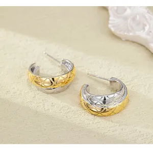 Close-up of dual-tone quilted pattern hoop earrings in gold and silver finish