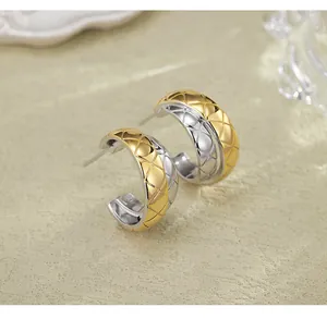 Close-up of two-tone quilted pattern hoop earrings with high-end metallic texture