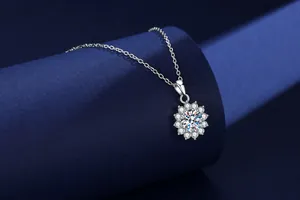 Sparkling moissanite sunflower pendant necklace in sterling silver on blue display