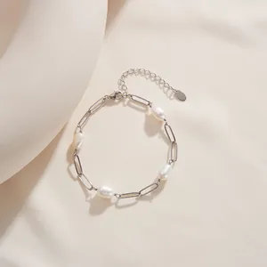 Close-up of s925 silver paperclip chain bracelet featuring natural baroque pearls