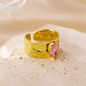 18k gold plated stainless steel open ring with hammered texture and pink zircon