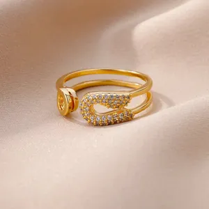 Gros plan détaillé d'une bague épingle de sûreté dorée avec pavé de zircons étincelants.