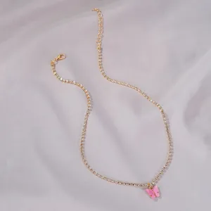 Gold-toned rhinestone choker necklace featuring a delicate pink butterfly pendant charm