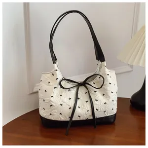 Stylish Korean style bow underarm bag with pleated texture and black bow accents