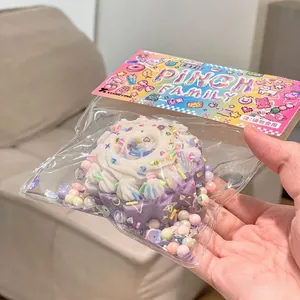 Detailed view of a cute purple cream cake squishy toy in clear packaging