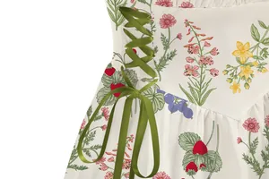 Close-up of elegant floral print dress with green ribbon lace-up detail for vacation