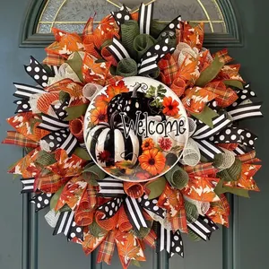 Macro view of an autumn harvest door wreath with vibrant maple leaves and pumpkins