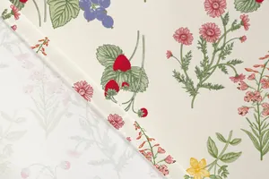 Detailed macro view of floral and strawberry print fabric for an elegant vacation dress.