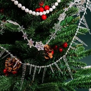 Detailed view of clear acrylic icicle and snowflake ornaments on a Christmas tree