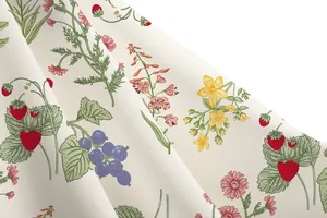 Close-up detail of vintage botanical floral and strawberry print on high-quality fabric
