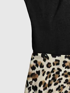 Detailed view showing the seam between black solid fabric and leopard print pattern