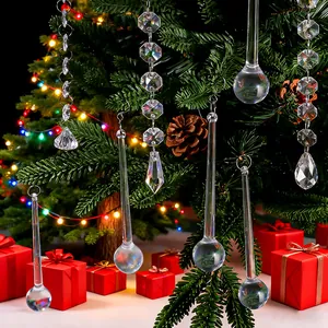 Detailed view of clear acrylic icicle ornaments hanging on a festive Christmas tree