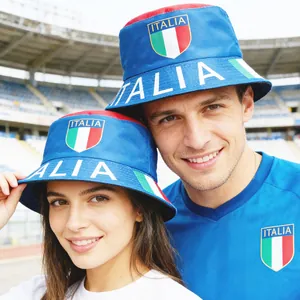 Close-up of a man and woman wearing blue Italian flag fan bucket hats in a stadium setting.