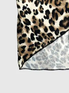 Detailed macro shot of leopard print fabric hem featuring precise black stitching lines.