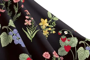 Macro detail of elegant strawberry and floral print on high-quality black dress fabric