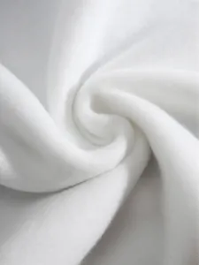Macro close-up of soft white fleece lining fabric showing thick fuzzy texture detail