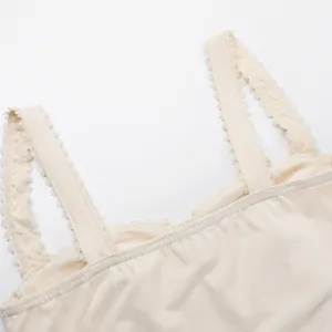 Close-up detail of cream lace trim straps on a slim fit camisole tank top for women