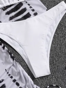 Dettaglio ravvicinato di slip bikini bianchi a vita alta con copricostume in rete stampata
