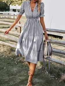 Detailed view of women's striped midi dress with V-neckline and ruffled sleeves