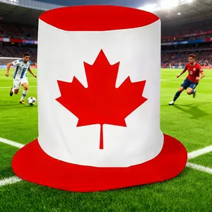 Detail of a Canada flag themed fan top hat placed on a football pitch stadium background