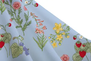 Macro detail of light blue fabric with vintage garden floral and strawberry print pattern