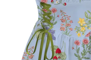 Detailed view of light blue floral print dress with olive green satin lace-up side ties.