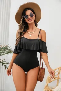 Detailed shot of a black one-piece swimsuit with elegant ruffles and thin straps.