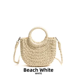 Elegant bohemian woven straw beach bag with round handle and shoulder strap in creamy white