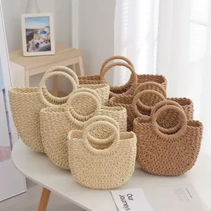 Handmade round handle straw woven beach bags in beige and brown, displayed in three sizes.