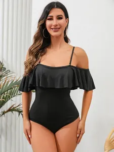 Chic black one-piece swimsuit featuring elegant ruffles and a ribbed texture for women.