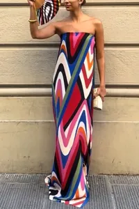 Strapless maxi dress with a vibrant wave print and a high side slit, shown on a model.