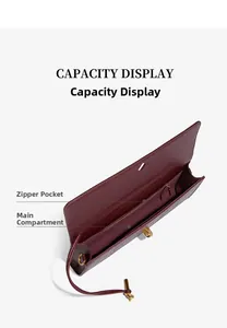 Detailed view of the interior compartments in a burgundy snakeskin baguette clutch.