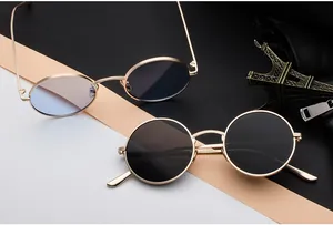 Vintage retro round and oval gold metal frame sunglasses with black and blue tinted lenses.