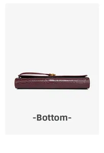 Macro view showing the bottom construction of a burgundy snake pattern baguette evening bag.