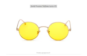 Detailed close-up of retro round metal frame sunglasses with vibrant yellow lenses