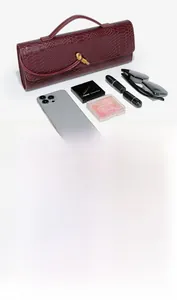 Detail view of burgundy snakeskin baguette clutch showing daily essentials storage capacity