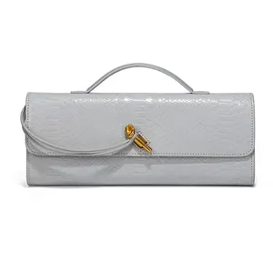 Elegant grey snake pattern baguette clutch bag with gold knot buckle and top handle