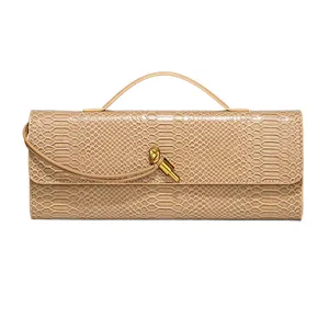 Elegant beige snakeskin baguette clutch handbag with metal knot clasp and handle.